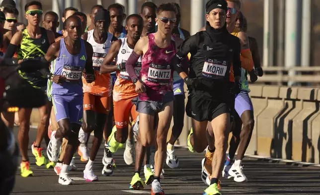 Yuma Morii, of Japan, right, makes his way across the Verrazzano Narrows bridge with the elite men's division runners during the New York City Marathon, Sunday, Nov. 3, 2024, in New York. (AP Photo/Yuki Iwamura)