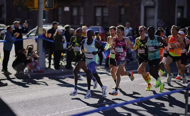 Runners in the men's elite division make their way through the Brooklyn borough during the New York City Marathon, Sunday, Nov. 3, 2024, in New York. (AP Photo/Eduardo Munoz Alvarez)