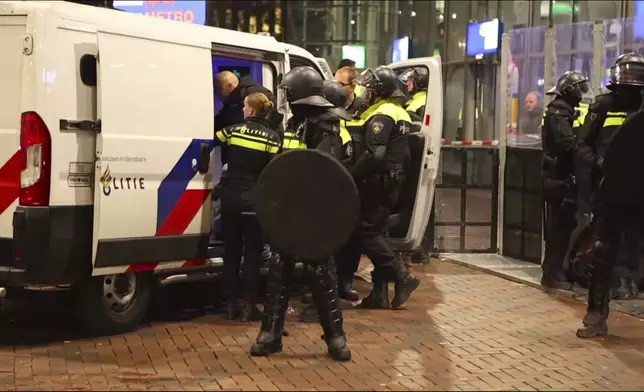 In this image taken from video, police detain a man near the Ajax stadium, after pro-Palestinian supporters marched despite a ban on pro-Palestinian demonstrations near the soccer stadium, in Amsterdam, the Netherlands, Thursday, Nov. 7, 2024. (AP Photo InterVision)