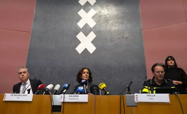 Amsterdam's Mayor Femke Halsema, centre, acting Amsterdam police chief Peter Holla, left, and head of the Amsterdam public prosecutor's office René de Beukelaer hold a news conference after Israeli fans and protesters clashed overnight after a soccer match, in Amsterdam, Netherlands, Friday Nov, 8, 2024. (AP Photo/Mike Corder)