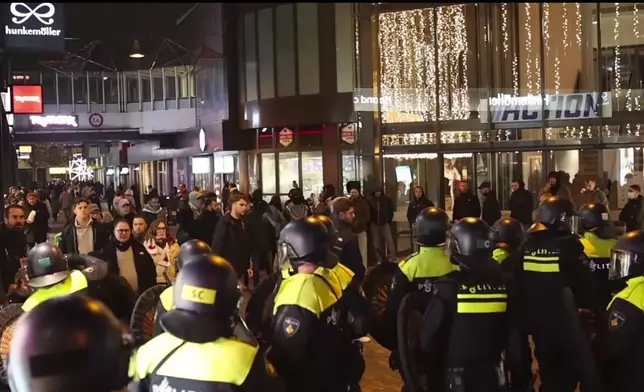 In this image taken from video, police stand guard forming a line near the Ajax stadium, in Amsterdam, the Netherlands, Thursday, Nov. 7, 2024. (AP Photo InterVision)