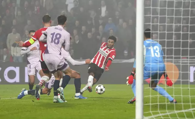 PSV's Malik Tillman, center, scores his side's second goal during the Champions League opening phase soccer match between PSV Eindhoven and Girona at Philips stadium in Eindhoven, Netherlands, Tuesday, Nov. 5, 2024. (AP Photo/Peter Dejong)