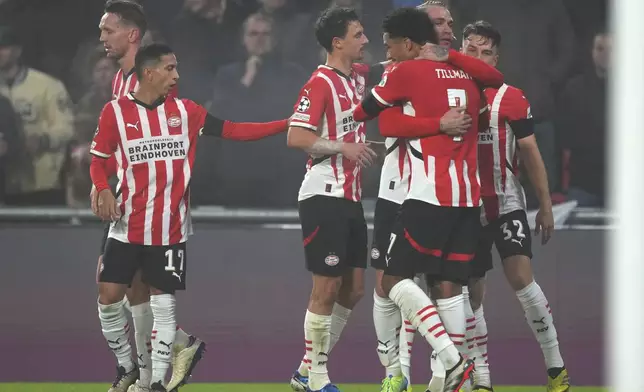 PSV's Malik Tillman, foreground, celebrates after scoring his side's second goal during the Champions League opening phase soccer match between PSV Eindhoven and Girona at Philips stadium in Eindhoven, Netherlands, Tuesday, Nov. 5, 2024. (AP Photo/Peter Dejong)