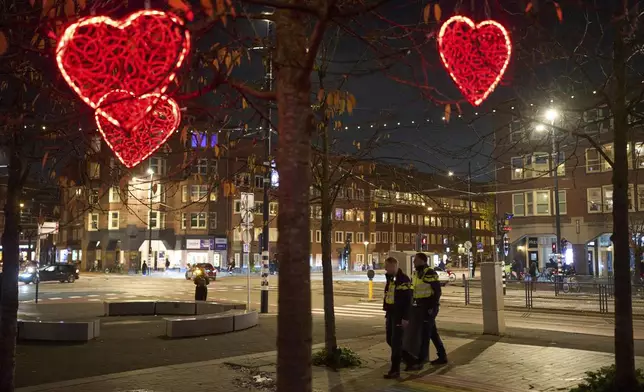 Police officers are seen patrolling the streets in Amsterdam, Netherlands, Tuesday, Nov. 12, 2024, as the city is facing tensions following violence last week. (AP Photo/Bram Janssen)