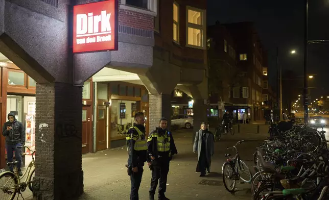 Police officers are seen patrolling the streets in Amsterdam, Netherlands, Tuesday, Nov. 12, 2024, as the city is facing tensions following violence last week. (AP Photo/Bram Janssen)