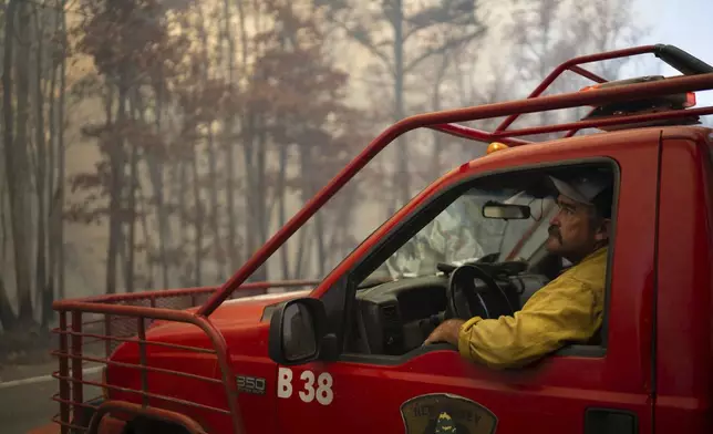 This photo provided by New Jersey Department of Environmental Protection firefighters respond to a forest fire on Wednesday, Nov. 6, 2024 in Evesham, N.J. (New Jersey Department of Environmental Protection via AP)