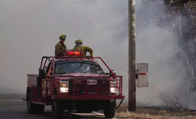 This photo provided by New Jersey Department of Environmental Protection firefighters respond to a forest fire on Wednesday, Nov. 6, 2024 in Evesham, N.J. (New Jersey Department of Environmental Protection via AP)