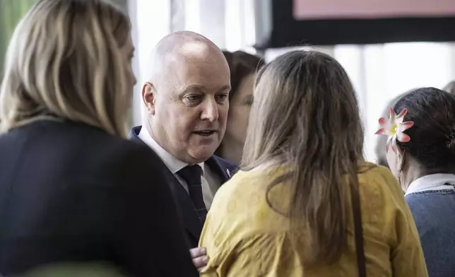 New Zealand's Prime Minister Christopher Luxon, center, greets survivors following his "formal and unreserved" apology in Parliament for the widespread abuse, torture and neglect of hundreds of thousands of children and vulnerable adults in care, in Wellington, New Zealand Tuesday, Nov. 12, 2024. (Monique Ford/Stuff via AP)