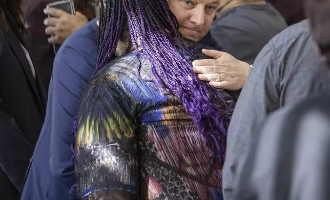 New Zealand's Prime Minister Christopher Luxon embraces a survivor following his "formal and unreserved" apology in Parliament for the widespread abuse, torture and neglect of hundreds of thousands of children and vulnerable adults in care, in Wellington, New Zealand, Tuesday, Nov. 12, 2024. (Monique Ford/Stuff via AP)