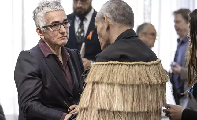 Solicitor-General Una Jagose, left, speaks with survivor Toni Jarvis following Prime Minister Christopher Luxon's "formal and unreserved" apology in Parliament for the widespread abuse, torture and neglect of hundreds of thousands of children and vulnerable adults in care, in Wellington, New Zealand Tuesday, Nov. 12, 2024. (Monique Ford/Stuff via AP)