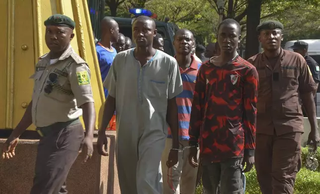 Children who had faced the death penalty for allegedly protesting against the country's cost of living crisis, are led to a courtroom in Abuja, Nigeria Tuesday, Nov. 5, 2024. (AP Photo/Olamikan Gbemiga)