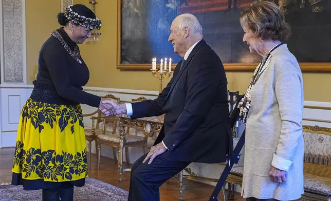 Norway's King Harald, centre, and Queen Sonja, right, welcome Rapa Nui Chilean politician Laura Tarita Rapu Alarcon, at the Royal Palace, in Oslo, Norway, Tuesday, Nov. 12, 2024. (Lise Aaserud/NTB Scanpix via AP)