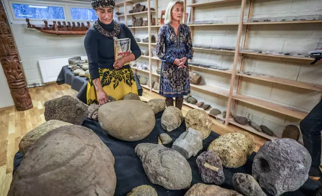 Kon-Tiki Museum's director Liv Heyerdahl, right, and Rapa Nui Chilean politician Laura Tarita Rapu Alarcon attend the "repatriation" ceremony for artifacts and human remains, at the Kon Tiki Museum in Oslo, Norway, Tuesday, Nov. 12, 2024. (Lise Åserud/NTB Scanpix via AP)