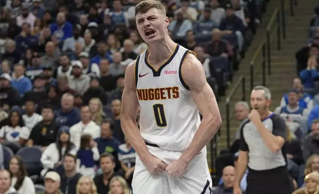 Denver Nuggets guard Christian Braun (0) celebrates after making a shot while fouled during the first half of an NBA basketball game against the Minnesota Timberwolves, Friday, Nov. 1, 2024, in Minneapolis. (AP Photo/Abbie Parr)