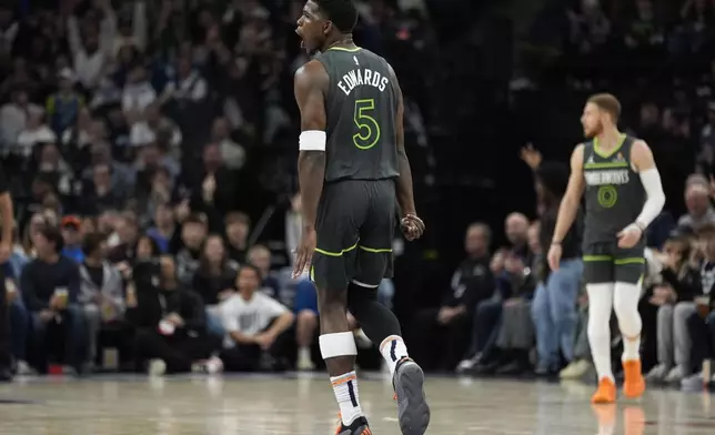 Minnesota Timberwolves guard Anthony Edwards (5) reacts after making a 3-point shot during the first half of an NBA basketball game against the Denver Nuggets, Friday, Nov. 1, 2024, in Minneapolis. (AP Photo/Abbie Parr)