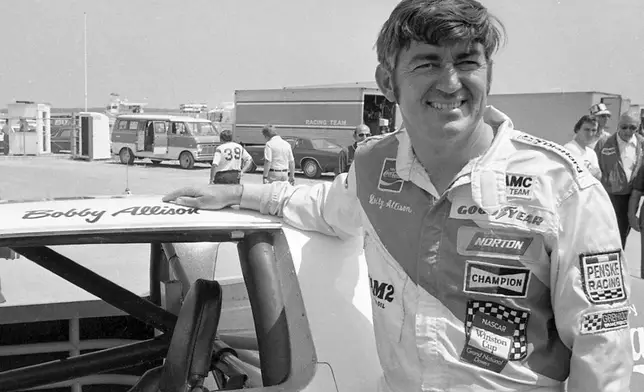 FILE - Bobby Allison stands beside his car and talks with the press after winning the pole position during qualifying for the 500 mile grand national stock car race at Pocono Raceway, Aug. 2, 1975, in Long Pond, Pa. (AP Photo/File)