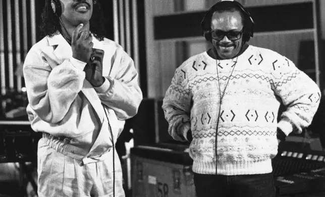 FILE - Recording star Stevie Wonder, left, and Quincy Jones participate in a coast-to-coast recording session, linked to a studio in New York, to record an anti-drug song, Wednesday, March 5, 1987 in Los Angeles. (AP Photo/Sunny Bak, File)