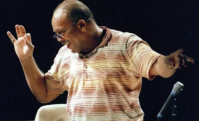 FILE - U.S. musician Quincy Jones directs the Orchestra National de France Tuesday, July 4, 2000, in Paris, during rehearsals prior the evening's unique concert. Quincy Jones died at age 91. (AP Photo/Laurent Emmanuel, File)