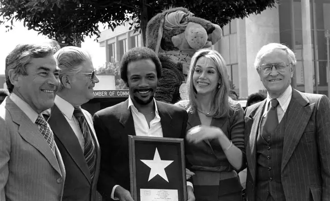 FILE - Musician Quincy Jones and his wife, actress Peggy Lipton, hold Jones' star which was placed in the Hollywood Walk of Fame in Los Angeles on March 14, 1980. (AP Photo/Barfield, File)