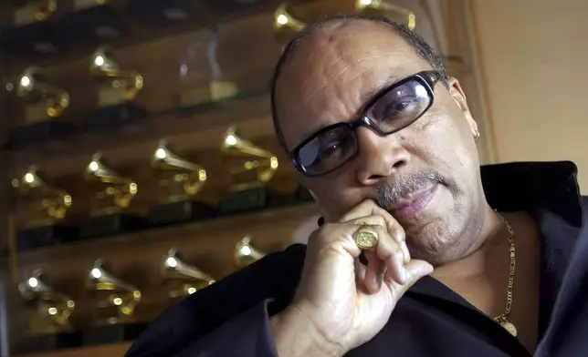 FILE - Legendary musician Quincy Jones poses amongst his many Grammy awards at his home in the Bel Air section of Los Angeles, Calif., Friday, April 9, 2004. Quincy Jones died at age 91. (AP Photo/Chris Pizzello, File)