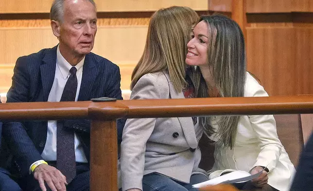 Karen Read, left, greets her mother Janet and father William at the start of the SJC hearing to remove some of the charges against her, in Boston, Wednesday, Nov. 6, 2024. (Greg Derr/The Patriot Ledger via AP, Pool)