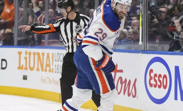 Edmonton Oilers' Leon Draisaitl celebrates his goal against the Vancouver Canucks during the first period of an NHL hockey game in Vancouver, on Saturday, Nov. 9, 2024. (Darryl Dyck/The Canadian Press via AP)