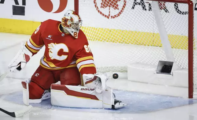 Calgary Flames goalie Dan Vladar lets in a goal by the Edmonton Oilers during first-period NHL hockey game action in Calgary, Alberta, Sunday, Nov. 3, 2024. (Jeff McIntosh/The Canadian Press via AP)