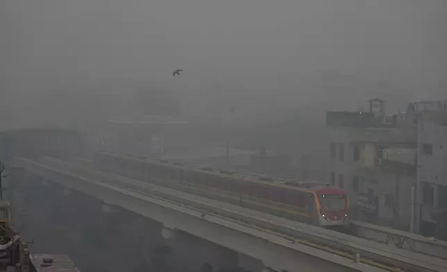 Orange Line Metro Train runs as heavy fog reduces visibility, in Lahore, Pakistan, Sunday, Nov. 3, 2024. (AP Photo/K.M. Chaudary)