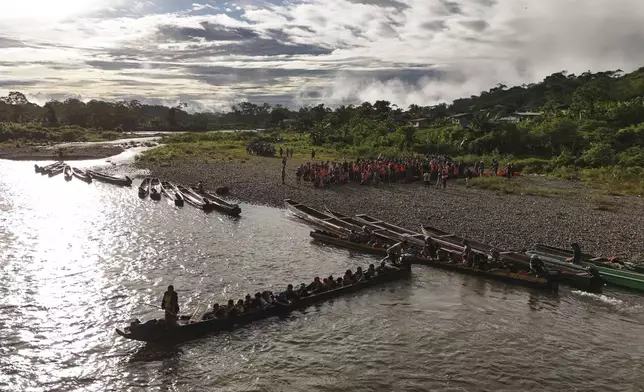 Migrants board boats to continue their journey north hoping to reach the United States after walking across the Darien Gap from Colombia in Bajo Chiquito, Panama, Saturday, Nov. 9, 2024. (AP Photo/Matias Delacroix)