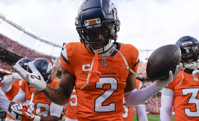 Denver Broncos cornerback Pat Surtain II (2) celebrates his interception during the second half of an NFL football game against the Carolina Panthers, Sunday, Oct. 27, 2024, in Denver. (AP Photo/Jack Dempsey)