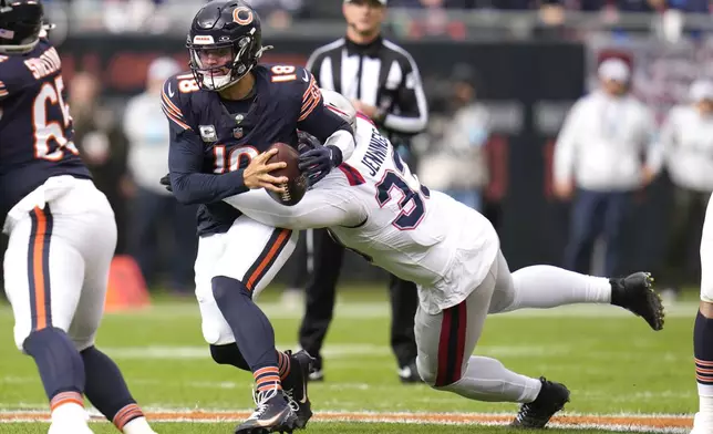 New England Patriots linebacker Anfernee Jennings (33) sacks Chicago Bears quarterback Caleb Williams during the first half of an NFL football game Sunday, Nov. 10, 2024, in Chicago. (AP Photo/Erin Hooley)