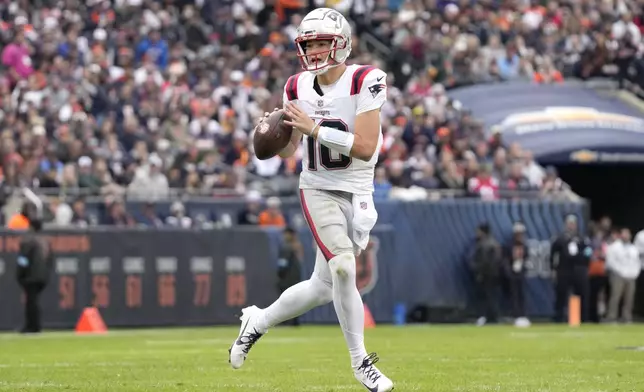 New England Patriots quarterback Drake Maye rolls out during the first half of an NFL football game against the Chicago Bears on Sunday, Nov. 10, 2024, in Chicago. (AP Photo/Nam Y. Huh)