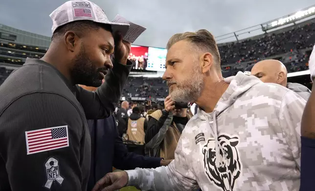 New England head Coach Jerod Mayo, left, and Chicago Bears head coach Matt Eberflus meet after the Bears' 19-3 loss to the Patriots in an NFL football game Sunday, Nov. 10, 2024, in Chicago. (AP Photo/Nam Y. Huh)