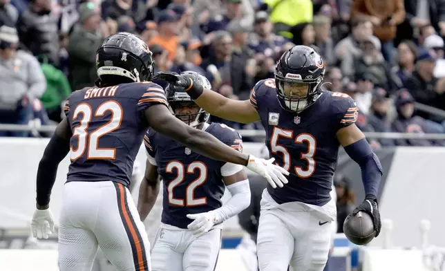 Chicago Bears linebacker T.J. Edwards (53) celebrates his interception of a New England Patriots quarterback Drake Maye pass with Terell Smith (32) during the first half of an NFL football game Sunday, Nov. 10, 2024, in Chicago. (AP Photo/Nam Y. Huh)