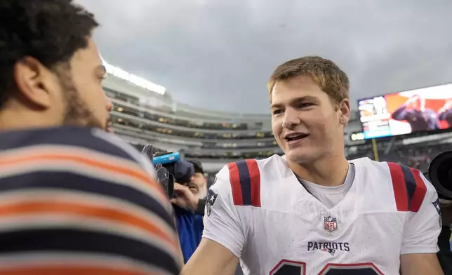 New England Patriots quarterback Drake Maye, right, and Chicago Bears quarterback Caleb Williams meet after the Patriots' win over the Bears in an NFL football game Sunday, Nov. 10, 2024, in Chicago. (AP Photo/Erin Hooley)