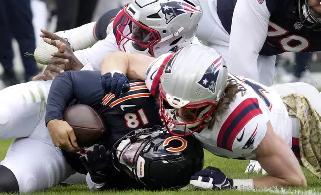 New England Patriots safety Brenden Schooler, right, sacks Chicago Bears quarterback Caleb Williams as linebacker Anfernee Jennings assists during the second half of an NFL football game Sunday, Nov. 10, 2024, in Chicago. (AP Photo/Nam Y. Huh)