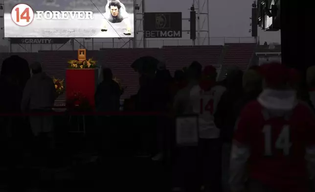 Baseball fans line up to pay their respects to Cincinnati Reds legend Pete Rose during a public visitation, Sunday, Nov. 10, 2024, at Great American Ball Park in Cincinnati. (AP Photo/Kareem Elgazzar)