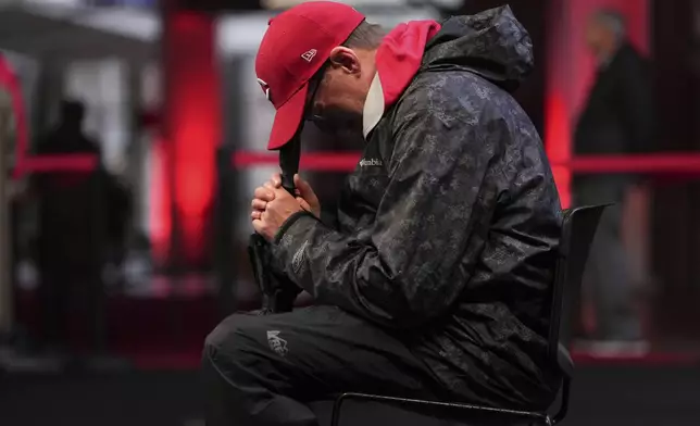 Joe Wilcox, 59, of Lexington, Ky., cries after paying his respects to Cincinnati Reds legend Pete Rose during a public visitation, Sunday, Nov. 10, 2024, at Great American Ball Park in Cincinnati. (AP Photo/Kareem Elgazzar)