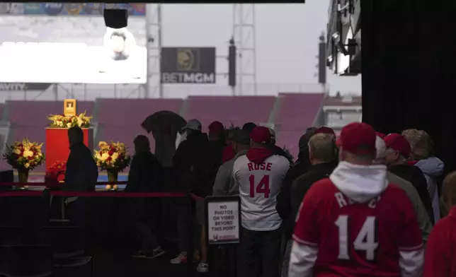 Baseball fans line up to pay their respects to Cincinnati Reds legend Pete Rose during a public visitation, Sunday, Nov. 10, 2024, at Great American Ball Park in Cincinnati. (AP Photo/Kareem Elgazzar)