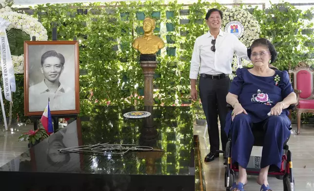 In this handout photo provided by the Malacanang Presidential Communications Office, Philippine President Ferdinand Marcos Jr., left, and his mother former First Lady Imelda Marcos, right, pose as they visit the tomb of the late strongman Ferdinand Marcos at the National Heroes Cemetery in Taguig City, Philippines on All Saints Day on Friday Nov. 1, 2024. (Malacanang Presidential Communications Office via AP)