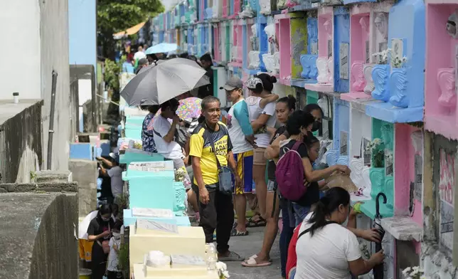 People visit apartment-type tombs of their departed loved ones at Manila's North Cemetery, Philippines as the nation observes All Saints Day on Friday, Nov. 1, 2024. (AP Photo/Aaron Favila)