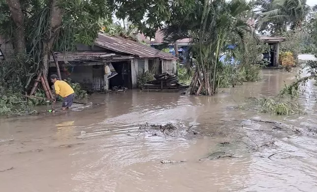 In this photo provided by the Local Government Unit (LGU) of Lal-lo, a resident wades along flooded areas caused by Typhoon Yinxing in Lal-lo, Cagayan province, northern Philippines Friday, Nov. 8, 2024. (LGU Lal-lo via AP)