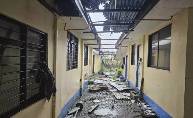 In this photo provided by the Provincial Disaster Risk Reduction and Management Office Cagayan, debris from damaged roof caused by Typhoon Yinxing are scattered beside an establishment in Sanchez Mira, Cagayan province, northern Philippines Friday Nov. 8, 2024. (Provincial Disaster Risk Reduction and Management Office, Cagayan via AP)