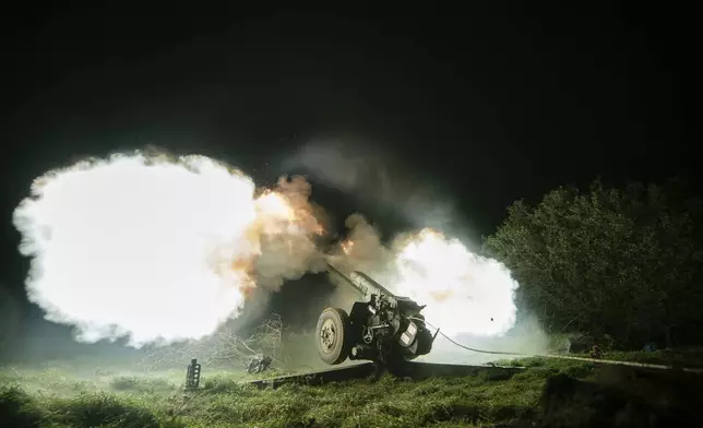 Ukrainian servicemen fire from a 122mm artillery cannon towards Russian positions in Kherson region, Ukraine, Sunday Oct. 27, 2024. (AP Photo/Marko Ivkov)