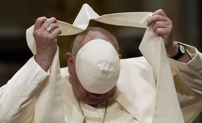 Pope Francis loses his scull cap during a meeting with diocesan community in the Basilica of St. John Lateran, in Rome, Friday, Oct. 25, 2024. (AP Photo/Alessandra Tarantino)