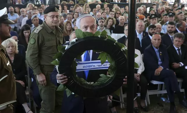 Israel's Prime Minister Benjamin Netanyahu takes part in a ceremony marking the Hebrew calendar anniversary of the Hamas attack on October 7 last year that sparked the ongoing war in Gaza, at the Mount Herzl military cemetery in Jerusalem, Israel Sunday Oct. 27, 2024. (Gil Cohen-Magen/Pool Photo via AP)