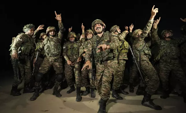 Indian army soldiers dance to celebrate Diwali, near Line of Control that divides Kashmir region between India and Pakistan, in Akhnoor sector, about 66 kilometers (41 miles) from Jammu, India, Monday, Oct. 28, 2024. (AP Photo/Channi Anand)