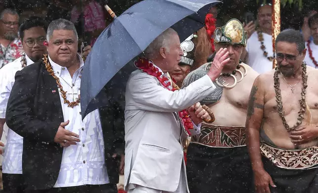 Britain's King Charles III waves as he departs after the bestowing and farewell ceremony on the final day of the royal visit to Samoa at the Siumu Village in Apia, Samoa, Saturday, Oct. 26, 2024. (Manaui Faulalo/Pool Photo via AP)