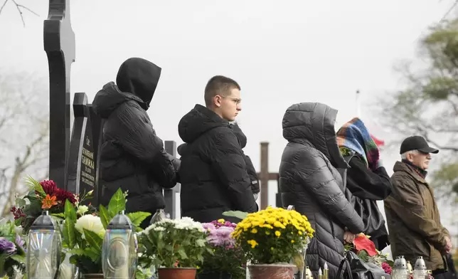 Candles burn on All Saints' Day, a time for reflecting on those who have died, on Friday Nov. 1, 2024, in Zakroczym near Warsaw, Poland. (AP Photo/Czarek Sokolowski)