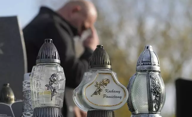 Candles burn in All Saints' Day, a time for reflecting on those who have died, on Friday Nov. 1, 2024, in Zakroczym near Warsaw, Poland. (AP Photo/Czarek Sokolowski)